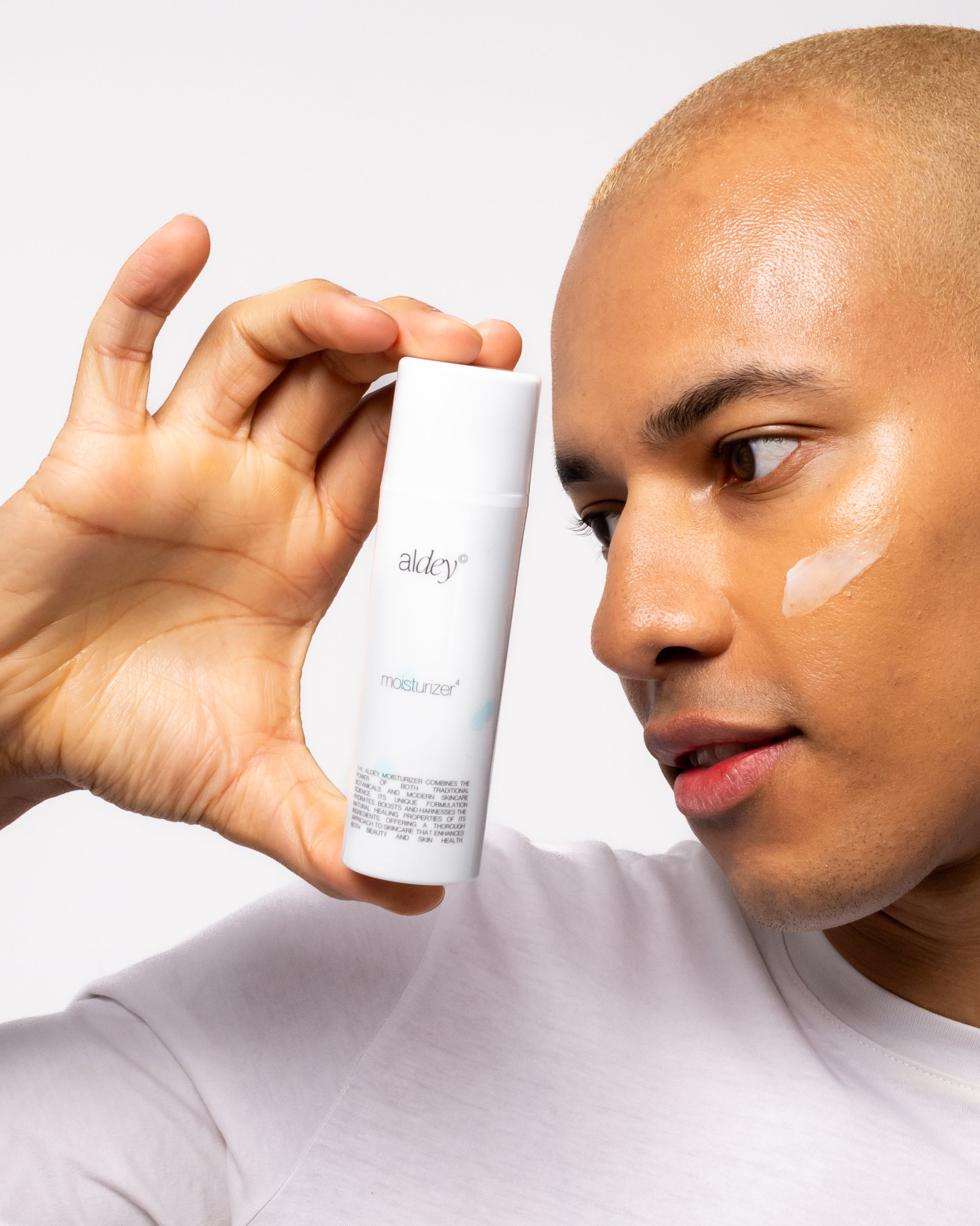 ALDEY moisturizer , a man is using it , his skin is glowing